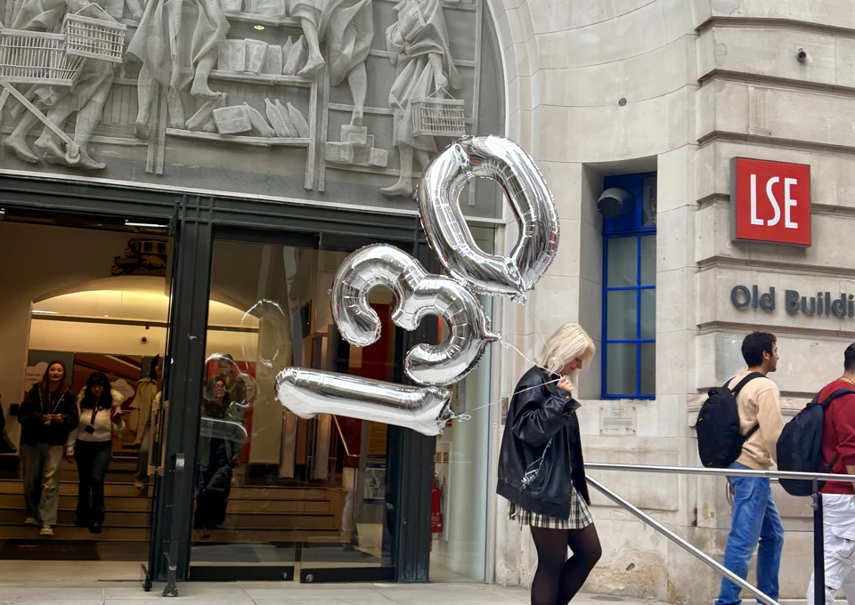 A girl carries silver 130 balloons